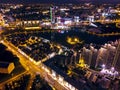 Picturesque night cityscape. Illuminated urban modern buildings, aerial top view